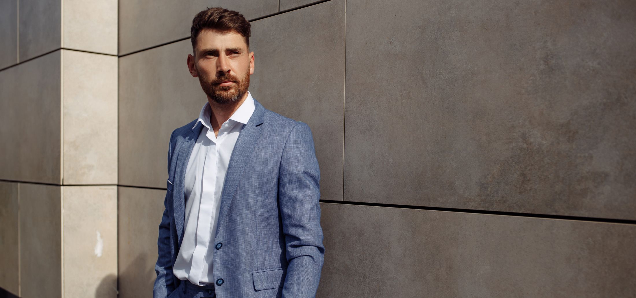 NYC male enhancement model wearing a blue jacket and white shirt