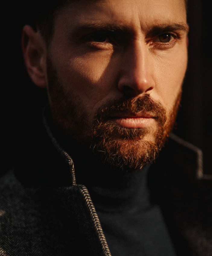 New York City penile enhancement model wearing black turtleneck shirt